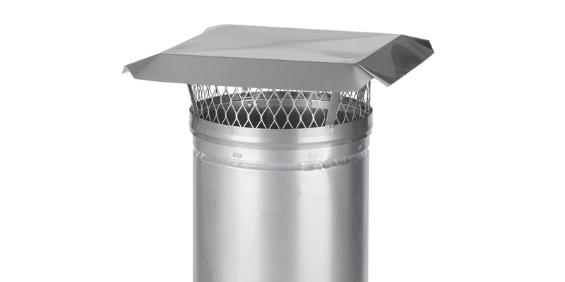 A Draft King Chimney Liner Cap installed on top of a liner flue against a white background.
