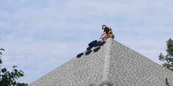picture of contractor on roof installing roof vent guards