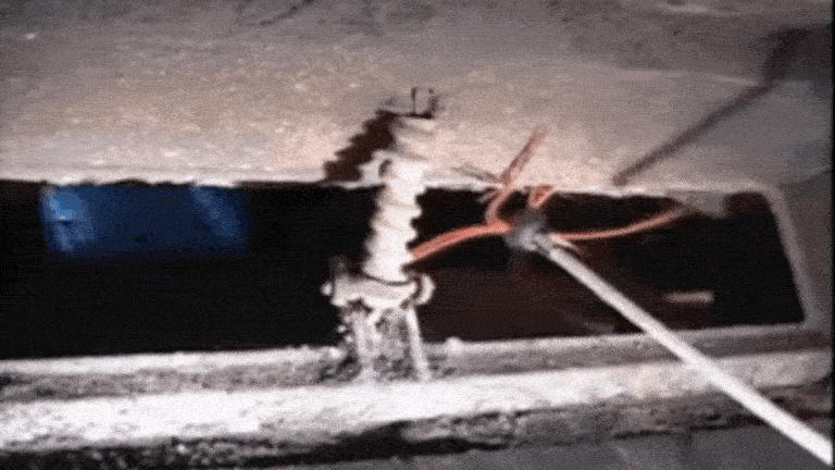 A GIF of a SootEater rotary chimney sweep tool workings its way up through a masonry flue from a firebox