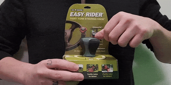 A person holding and rotating a Good Vibrations Easy-Rider Tight-Turn Steering Knob while facing the camera