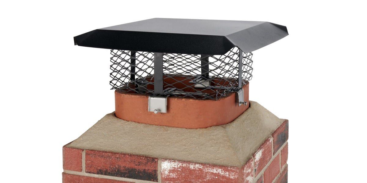 A black galvanized adjustable bolt-on HY-C chimney cap installed on a chimney flue against a white background