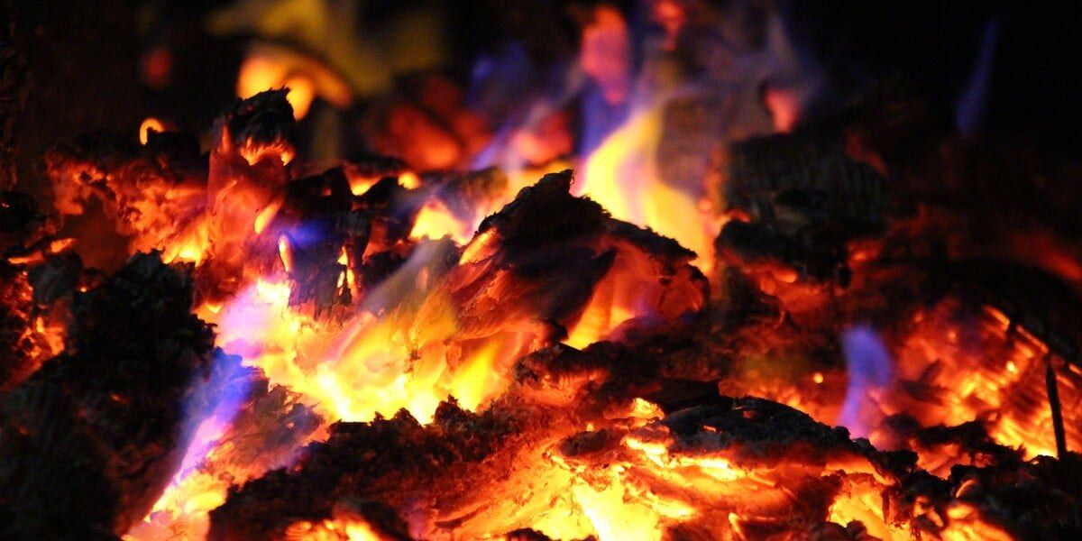 Close-up of a smoldering fire that's starting to die down
