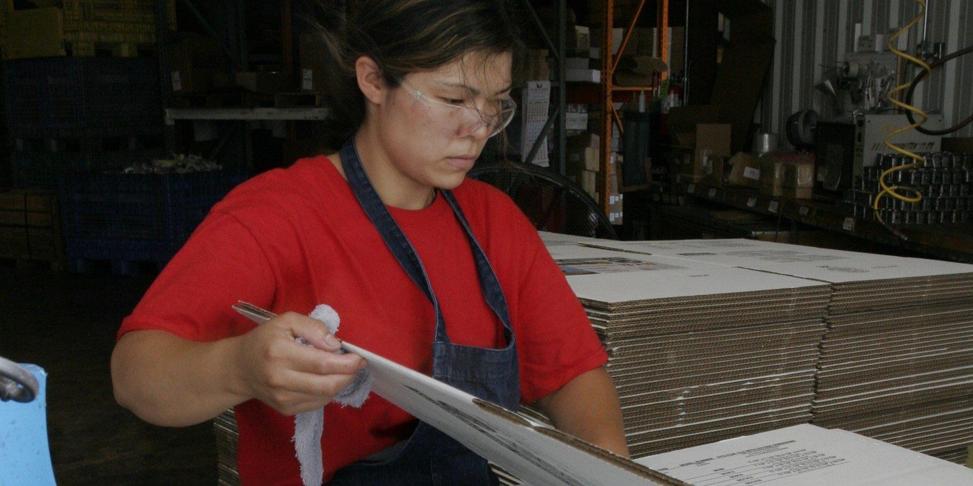 Lupe, a HY-C factory employee, folding boxes together on the packaging line