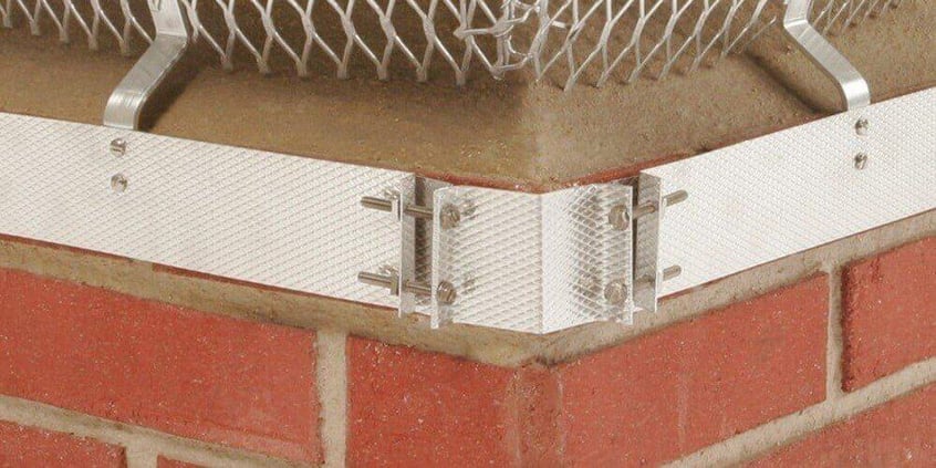 A close-up of the corner-mount bolt system of a Duro Shield Band-Around-Brick Chimney Cap.