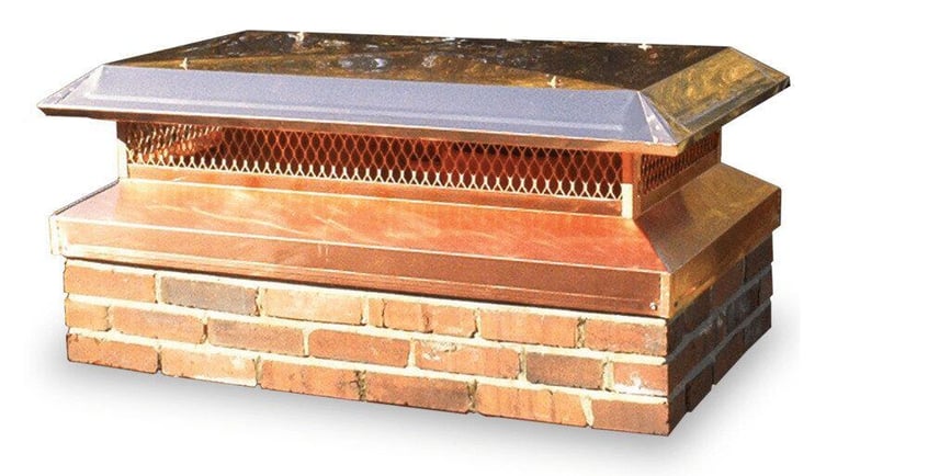 A Draft King custom copper skirt-type chimney cap installed on a multi-flue chimney.
