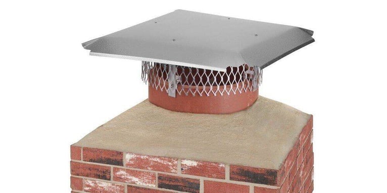 An aluminum multi-fit chimney cap installed on a round chimney flue against a white background.