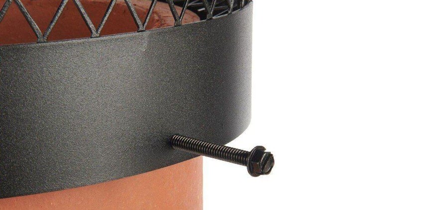 A close-up of the bolt-on connection point of a round black galvanized steel chimney cap.