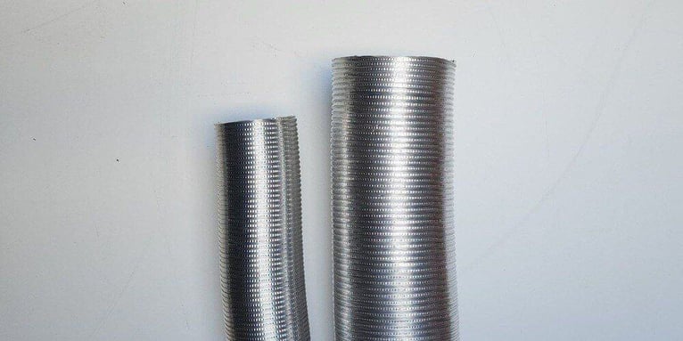 Two round chimney flue liners with different diameters resting side by side against a white backdrop.