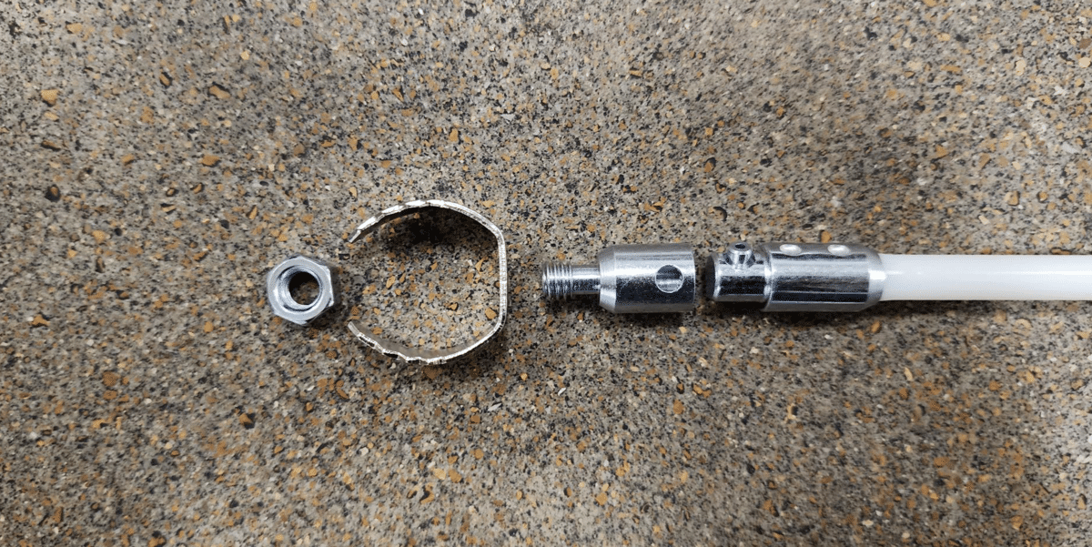 A rod, drill bit connector, blockage removal tool, and nut of a dryer vent cleaning kit