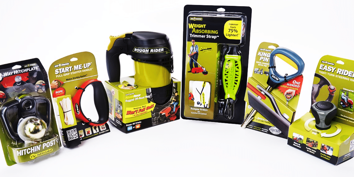 A lineup of six Good Vibrations products on a white background, from left to right: the Hitchin' Post+, the Start Me Up lawn mower pull cord handle, the Rough Rider drinking mug, the Zero Gravity trimmer strap, the King Pin hitch pin, and the Easy-Rider steering wheel knob