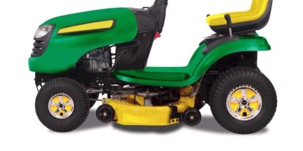 A green and yellow tractor with chrome and yellow Good Vibrations Wheelies Tractor Wheel Covers installed on the two visible wheels