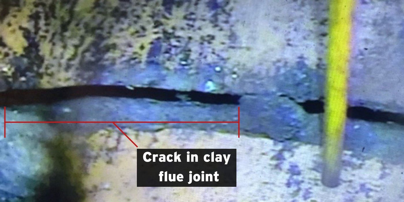 A shot of the inside of a masonry flue tile showing a crack in one of the clay flue joints