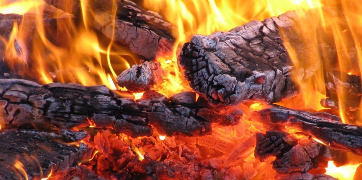 Ashen firewood burning up in a fire