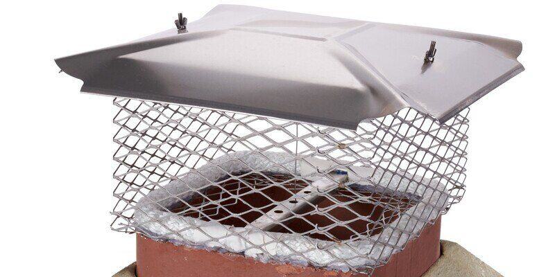 A Draft King Universal Chimney Cap with a chimney damper installed on it. The damper is in the open position.