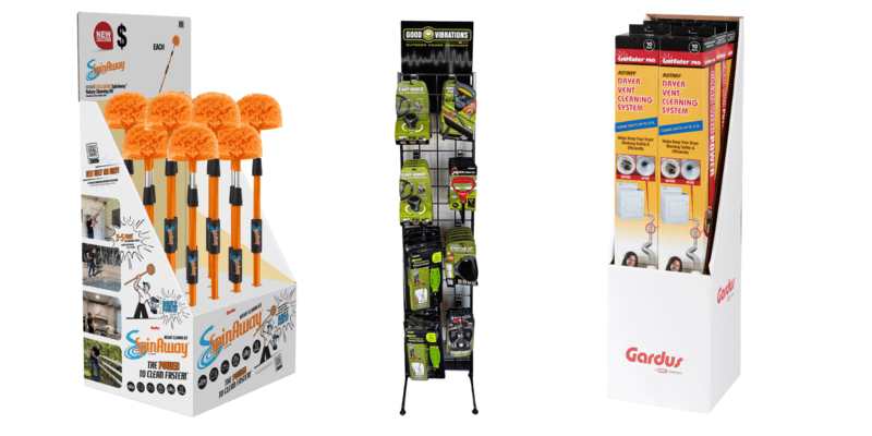 A SpinAway cardboard display, a Good Vibrations peg rack, and a Gardus LintEater cardboard display all set against a white background.