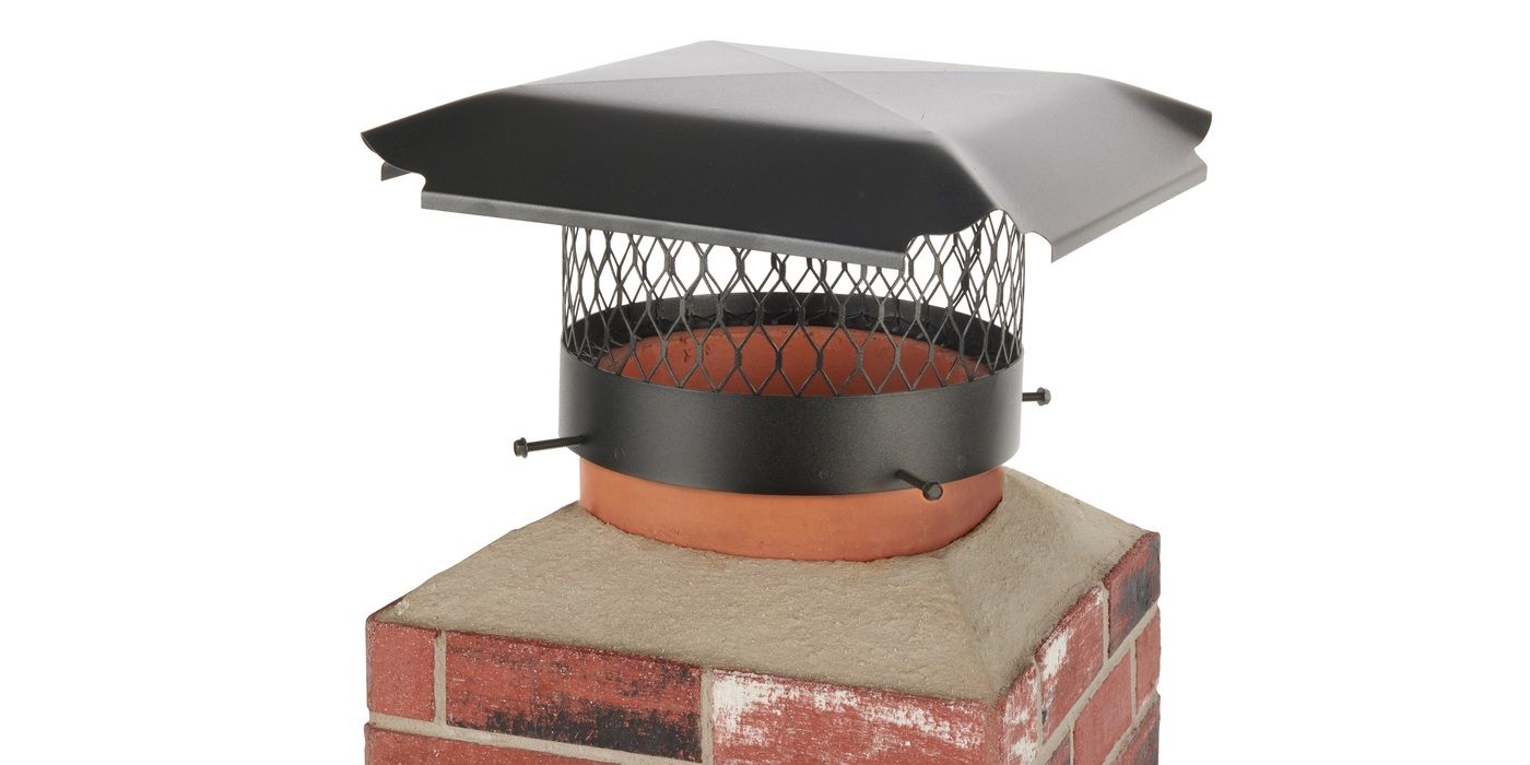 A round Draft King single-flue galvanized steel chimney cap on a mock chimney flue against a white background.