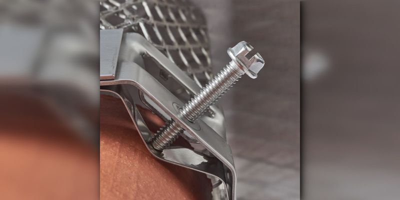 A close-up of the protective metal strip on the corner of a stainless steel Draft King chimney cap.