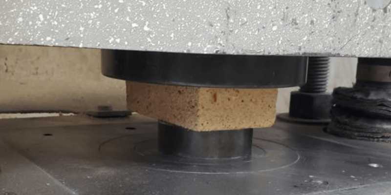 An Alsey Refractories Co. firebrick undergoing a cold crushing strength test in a testing laboratory.