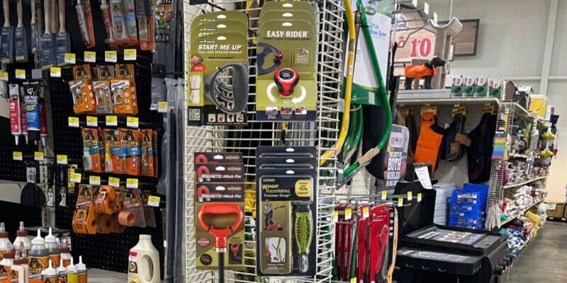 A collection of Good Vibrations display products set up on a power wing on an endcap in hardware store.