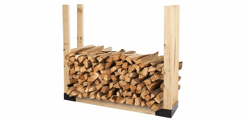 A Shelter Firewood Rack Bracket Kit with 6 two-by-fours installed. There is firewood stacked on the finished log rack.