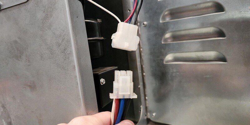  A close-up of the plug-and-play-style electrical components of a Shelter SF1000E wood burning furnace.