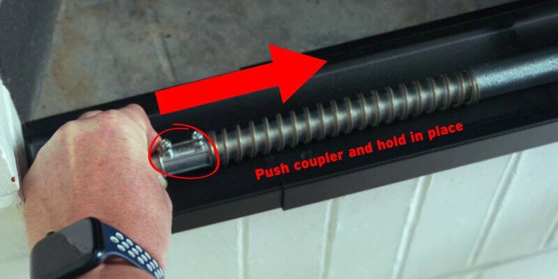An image with arrows and texts demonstrating the steps of using the half-inch coupler to provide spring tension on a Liberty Foundry Co. Smoke Guard.
