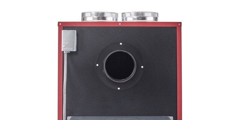 A closeup of the 6-inch chimney connection port on the back of a Fire Chief FC1000E wood-burning furnace.