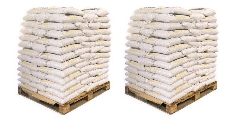 Two pallets of wood pellet fuel, each filled with 100 bags of pellets. The pallets and pellets are displayed against a white background.