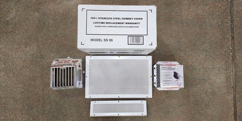 A chimney cap, two dryer vent guards, a soffit vent screen, and a foundation vent screen, all in their retail packaging on a concrete floor.