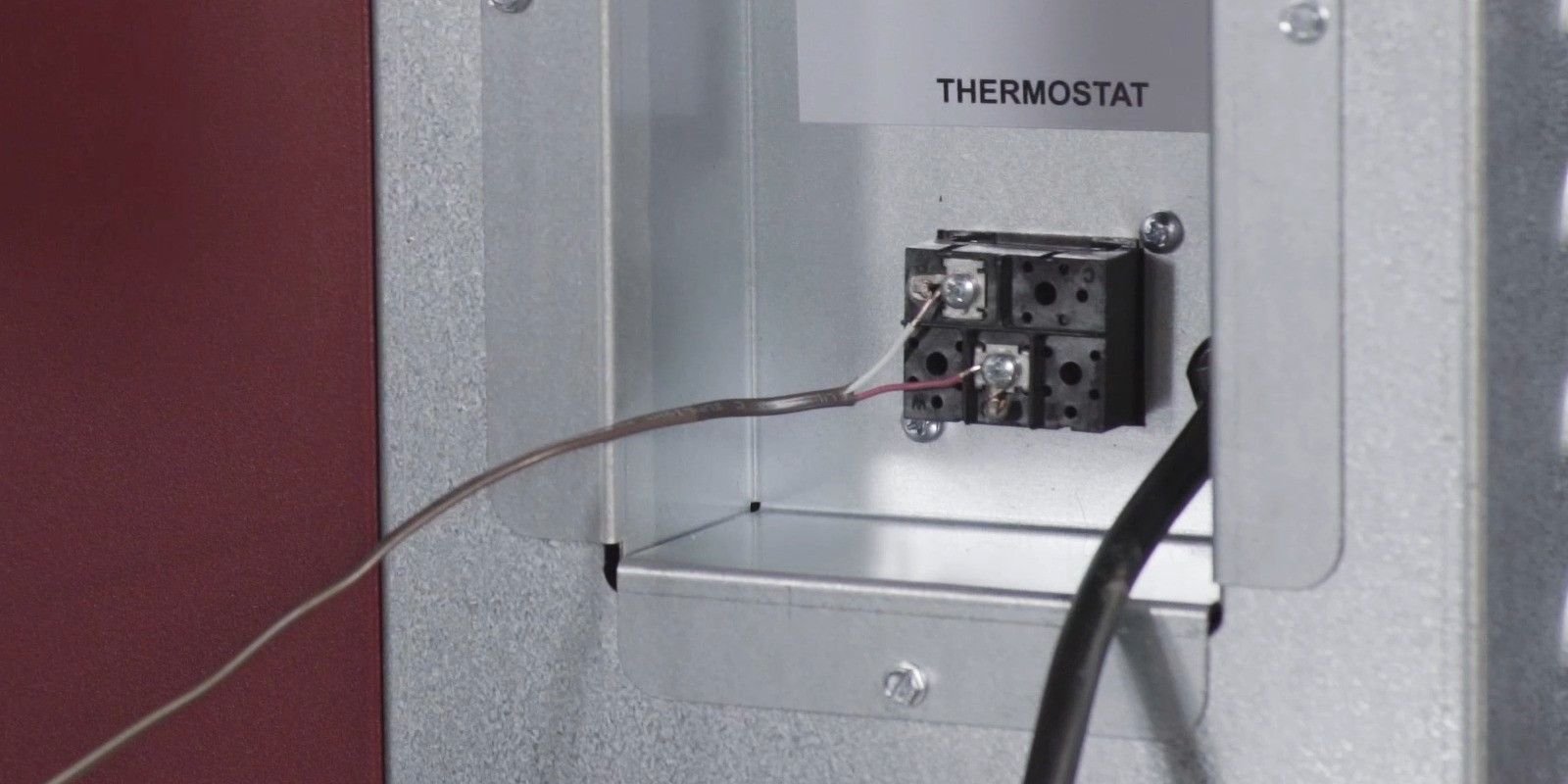 A close up of the thermostat connection point on a Fire Chief FC1000E wood burning furnace.