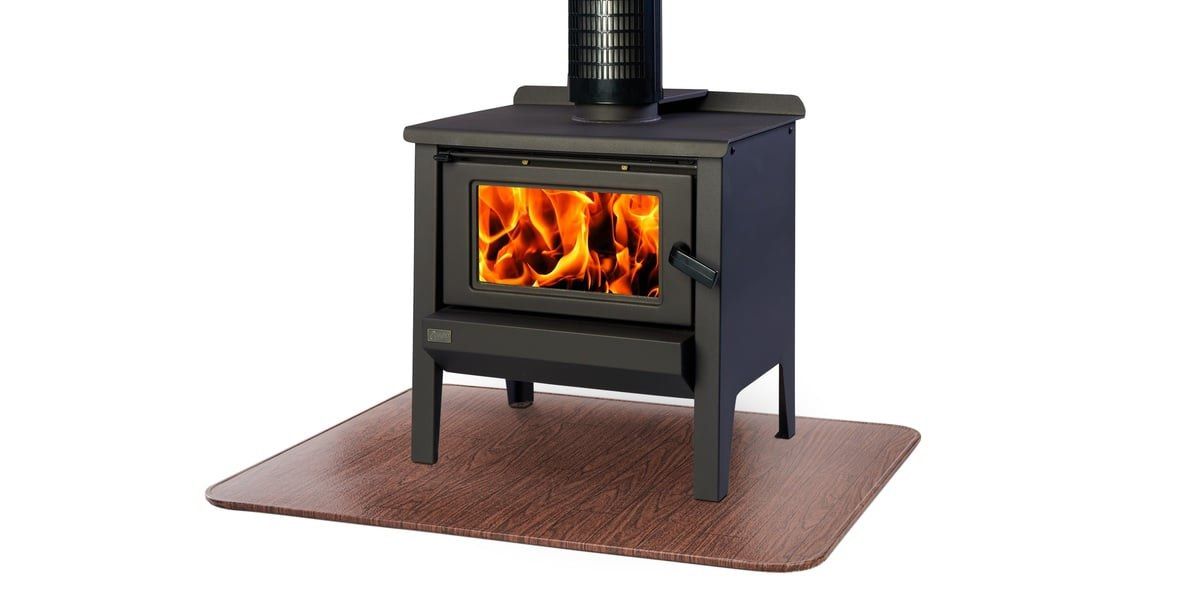 A wood stove with a fire burning inside it sitting on top of a woodgrain HY-C stove board.