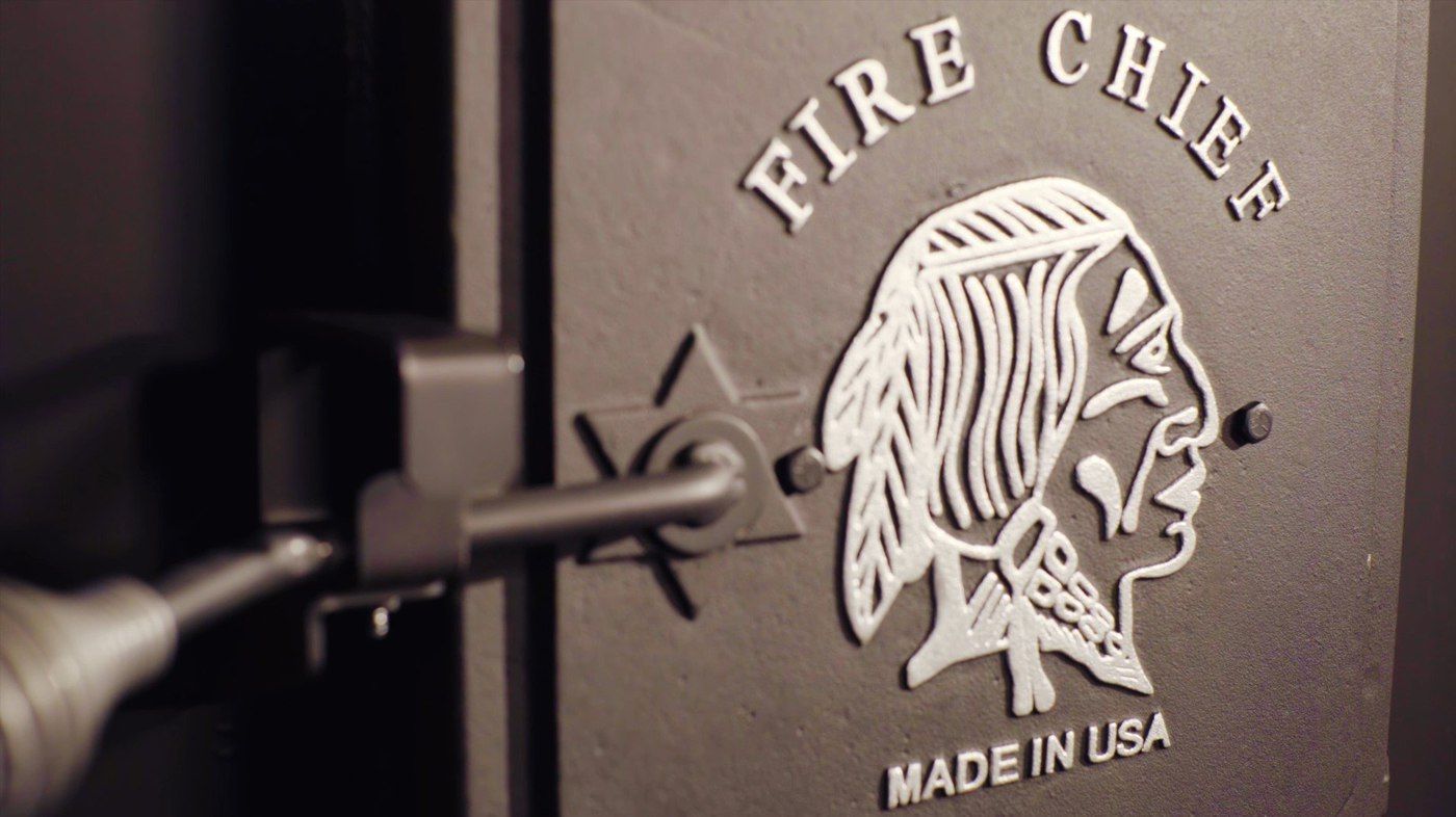 A close-up of the firebox door of a Fire Chief FC1000E wood burning furnace.