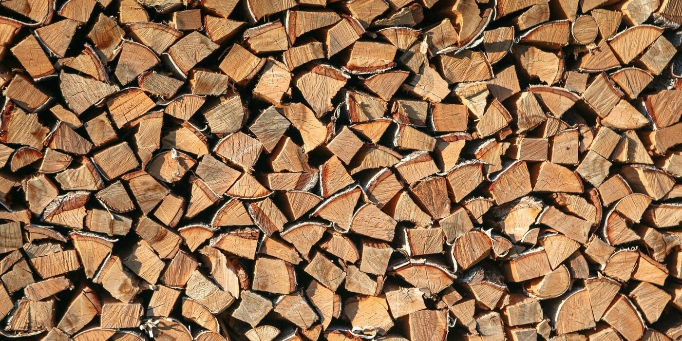 A close-up of a stack of several split logs of firewood.